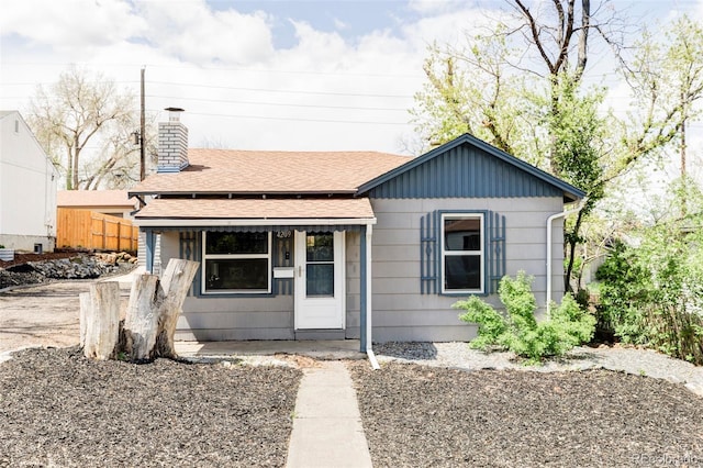 4209 S Bannock St, Englewood, CO 80110 - bungalow-style house featuring a shingled roof, a porch, and a chimney