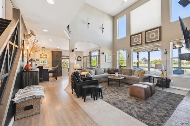14953 Akron Ct, Brighton, CO 80602 - living room with light wood-type flooring, plenty of natural light, a high ceiling, recessed lighting, and baseboards