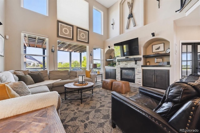 14953 Akron Ct, Brighton, CO 80602 - living area featuring a towering ceiling, healthy amount of natural light, and a stone fireplace