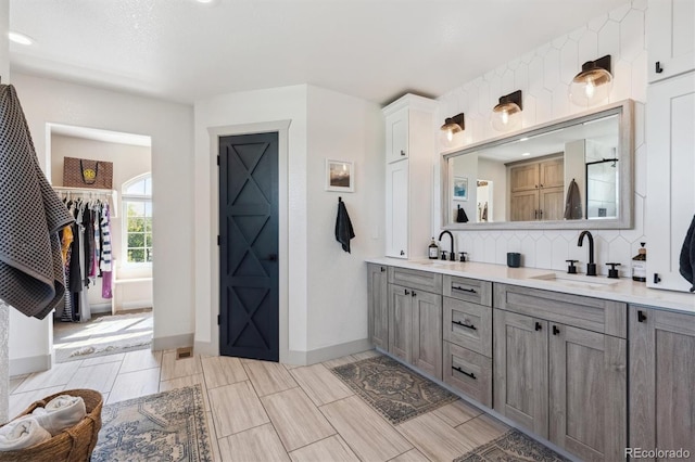 14953 Akron Ct, Brighton, CO 80602 - full bath featuring baseboards, double vanity, decorative backsplash, and recessed lighting