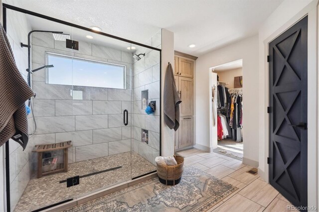 14953 Akron Ct, Brighton, CO 80602 - bathroom with a shower stall, recessed lighting, baseboards, and a spacious closet