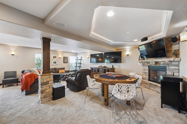 14953 Akron Ct, Brighton, CO 80602 - living area featuring carpet floors, a stone fireplace, a tray ceiling, and ornate columns