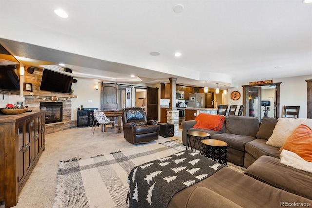 14953 Akron Ct, Brighton, CO 80602 - living area featuring light colored carpet, a fireplace, and recessed lighting