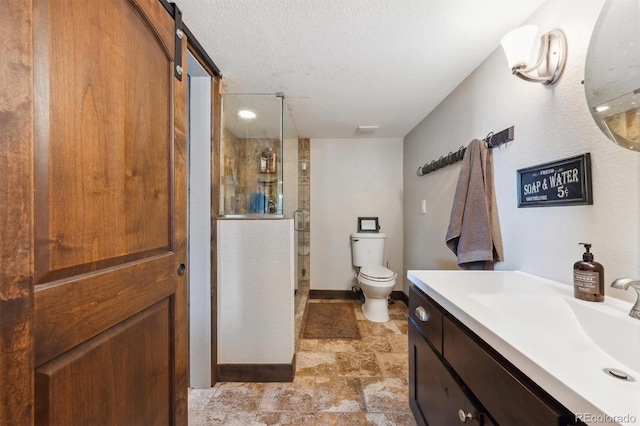 14953 Akron Ct, Brighton, CO 80602 - bathroom featuring toilet, a stall shower, stone finish flooring, vanity, and a textured ceiling