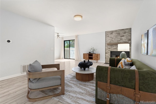 580 Vance St Unit A, Lakewood, CO 80226 - living area featuring a tile fireplace, wood finished floors, and a ceiling fan