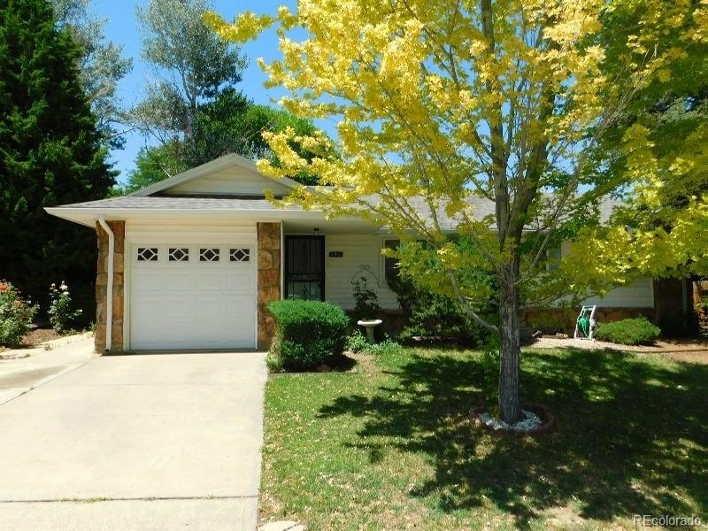 single story home with a garage and a front lawn