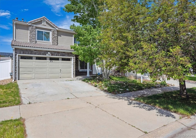 4435 Andes Ct, Denver, CO 80249 - view of front of property with a tile roof, driveway, stone siding, an attached garage, and fence