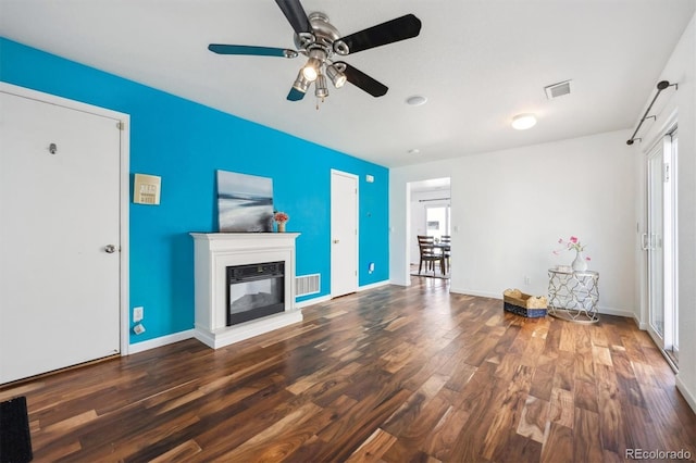 4435 Andes Ct, Denver, CO 80249 - unfurnished living room featuring ceiling fan, wood finished floors, a glass covered fireplace, and baseboards