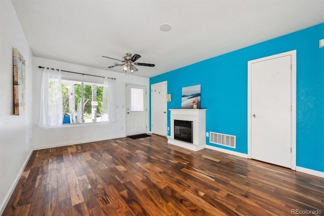 4435 Andes Ct, Denver, CO 80249 - unfurnished living room featuring wood finished floors, baseboards, a ceiling fan, and a glass covered fireplace