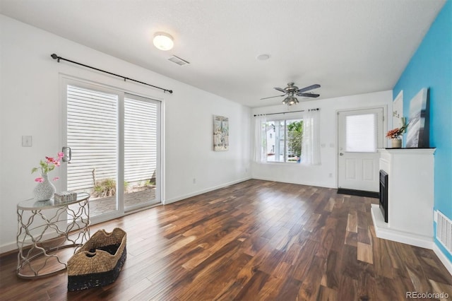 4435 Andes Ct, Denver, CO 80249 - unfurnished living room featuring wood finished floors, ceiling fan, baseboards, and a fireplace with raised hearth