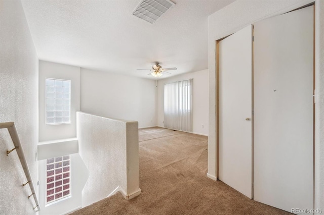 4435 Andes Ct, Denver, CO 80249 - hallway with light carpet and an upstairs landing