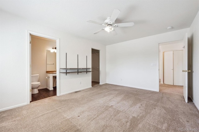 4435 Andes Ct, Denver, CO 80249 - unfurnished bedroom featuring carpet, a walk in closet, baseboards, ensuite bathroom, and a closet