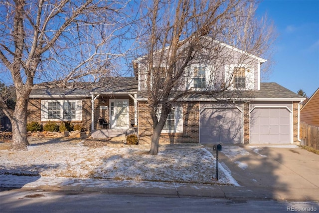 tri-level home with a garage, concrete driveway, and brick siding