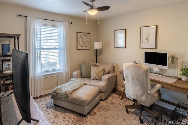 home office featuring ceiling fan, baseboards, and light wood-style flooring