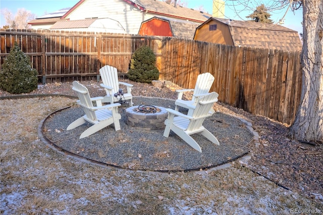 view of patio featuring an outdoor fire pit and a fenced backyard