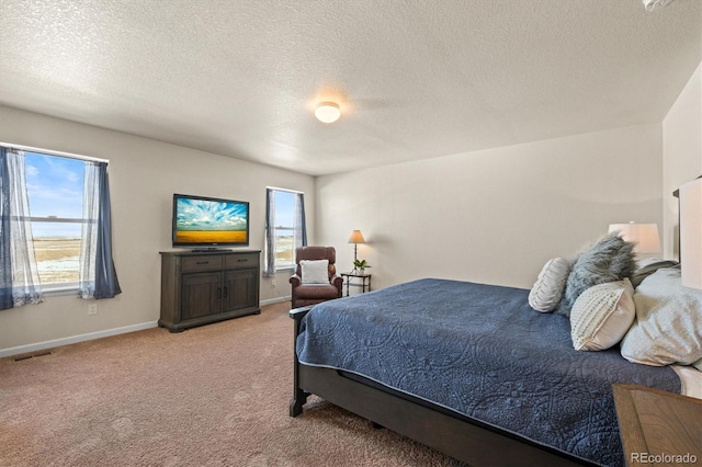 bedroom featuring light colored carpet and a textured ceiling