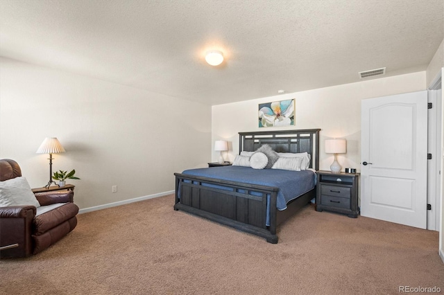 bedroom featuring light colored carpet and a textured ceiling