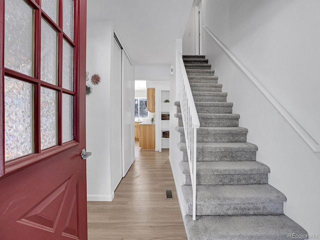 stairs featuring wood-type flooring