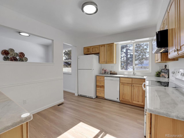 kitchen with white appliances, light hardwood / wood-style floors, plenty of natural light, and sink