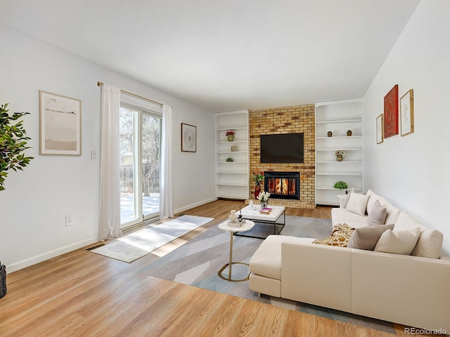 living room featuring a fireplace and light wood-type flooring