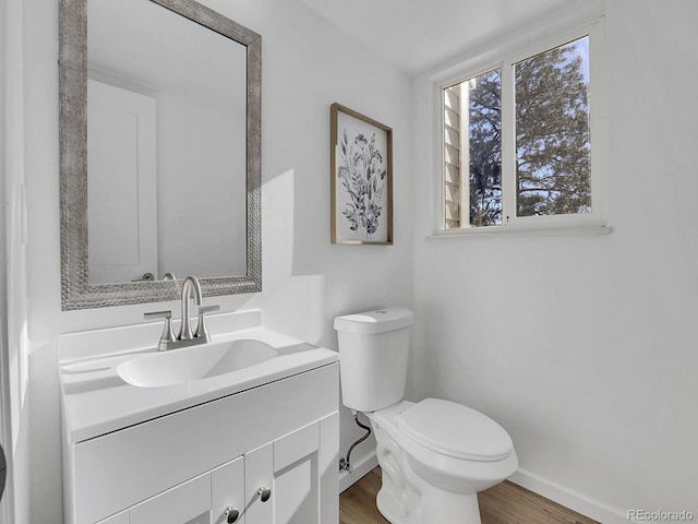 bathroom featuring hardwood / wood-style floors, vanity, and toilet