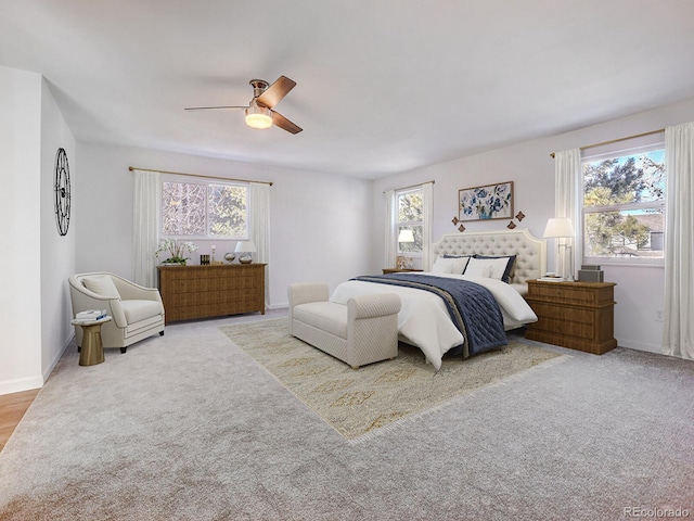 bedroom featuring light colored carpet and ceiling fan