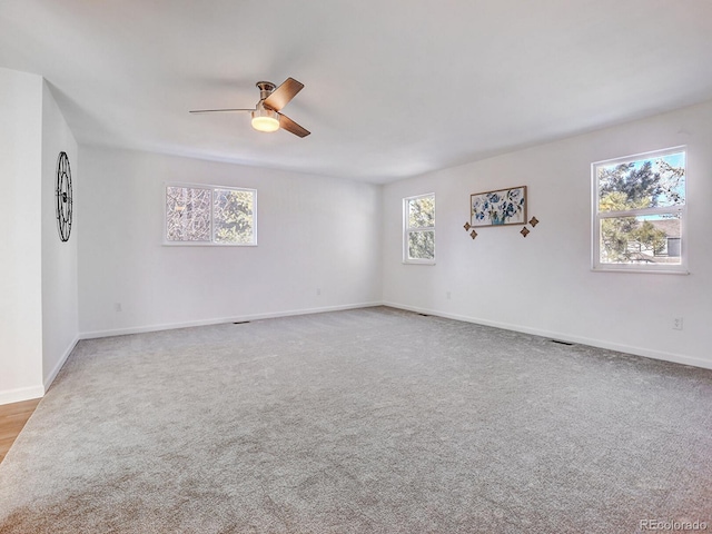 carpeted empty room featuring ceiling fan