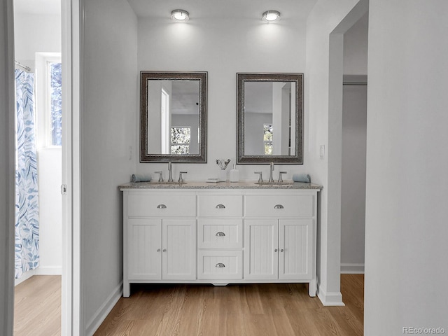 bathroom with vanity and hardwood / wood-style floors