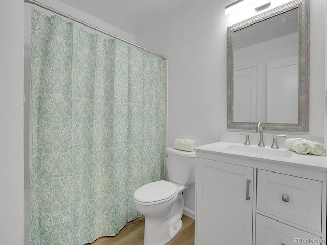 bathroom featuring toilet, a shower with curtain, wood-type flooring, and vanity