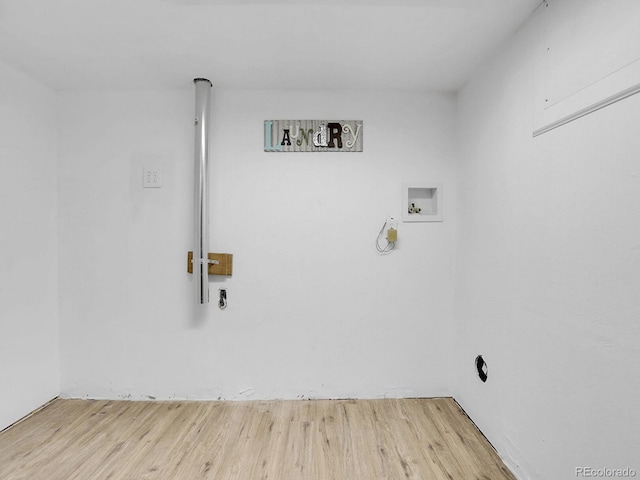 clothes washing area with washer hookup and light wood-type flooring