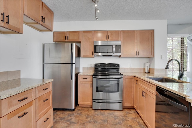 4802 E Kentucky Ave Unit E, Denver, CO 80246 - kitchen with stainless steel appliances, a sink, a textured ceiling, and light stone counters