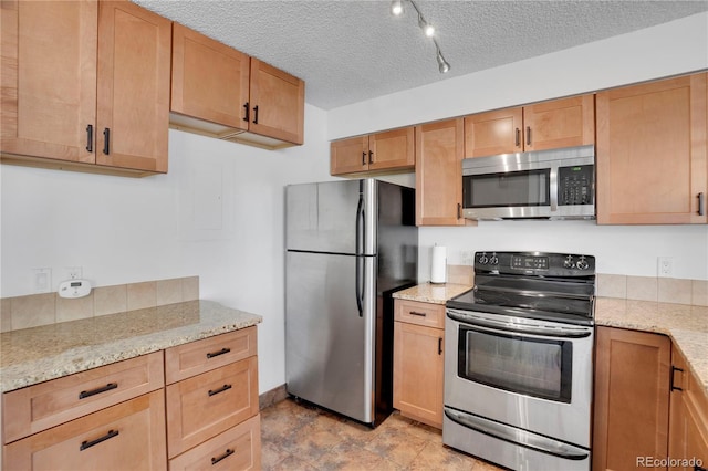 4802 E Kentucky Ave Unit E, Denver, CO 80246 - kitchen featuring appliances with stainless steel finishes, a textured ceiling, and light stone counters