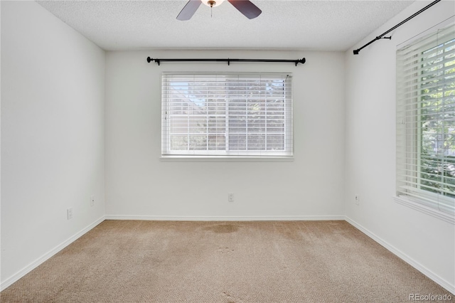 4802 E Kentucky Ave Unit E, Denver, CO 80246 - carpeted empty room with a textured ceiling, plenty of natural light, a ceiling fan, and baseboards