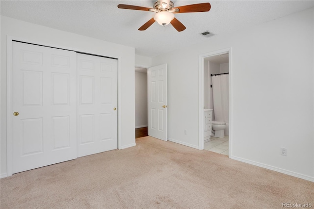 4802 E Kentucky Ave Unit E, Denver, CO 80246 - unfurnished bedroom featuring carpet flooring, a closet, baseboards, ensuite bath, and a ceiling fan