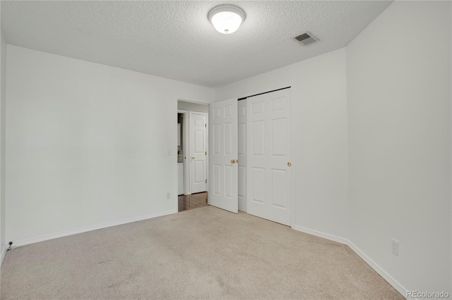 4802 E Kentucky Ave Unit E, Denver, CO 80246 - unfurnished bedroom featuring carpet flooring, a textured ceiling, baseboards, and a closet