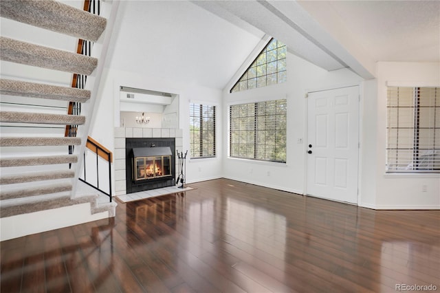 4802 E Kentucky Ave Unit E, Denver, CO 80246 - unfurnished living room featuring stairway, plenty of natural light, wood finished floors, and vaulted ceiling