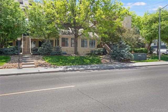 4802 E Kentucky Ave Unit E, Denver, CO 80246 - obstructed view of property featuring stairs and a front yard