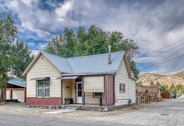 124 E 8th St, Salida, CO 81201 - view of front of home with a mountain view, metal roof, and covered porch