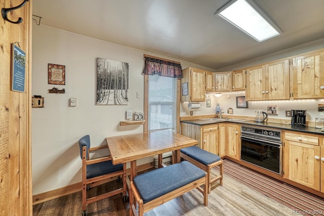 124 E 8th St, Salida, CO 81201 - kitchen with black oven, light brown cabinets, and dark countertops