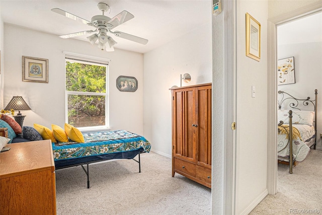 3300 W Florida Ave Unit 51, Denver, CO 80219 - bedroom with light carpet, a ceiling fan, and baseboards