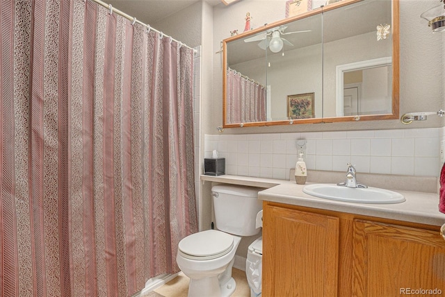 3300 W Florida Ave Unit 51, Denver, CO 80219 - full bathroom featuring toilet, a ceiling fan, vanity, and tasteful backsplash