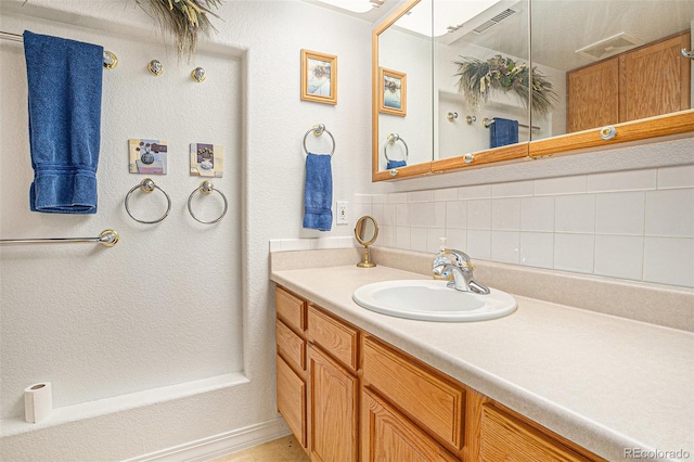 3300 W Florida Ave Unit 51, Denver, CO 80219 - bathroom featuring vanity and backsplash