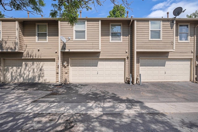 3300 W Florida Ave Unit 51, Denver, CO 80219 - view of front facade with a garage and driveway