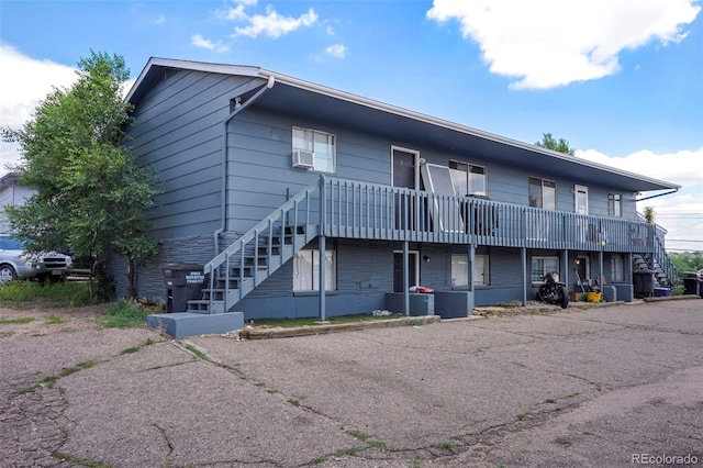 exterior space featuring central air condition unit, cooling unit, and stairs