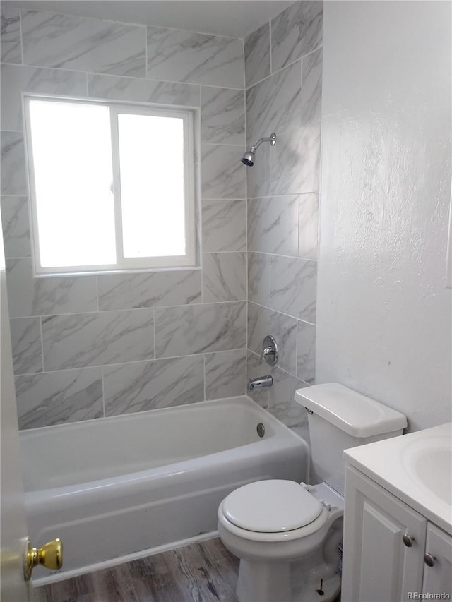 full bathroom with wood finished floors, toilet, bathtub / shower combination, and vanity