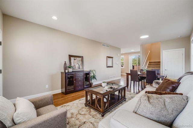 19294 E Warren Pl, Aurora, CO 80013 - living area with stairway, light wood finished floors, baseboards, and recessed lighting