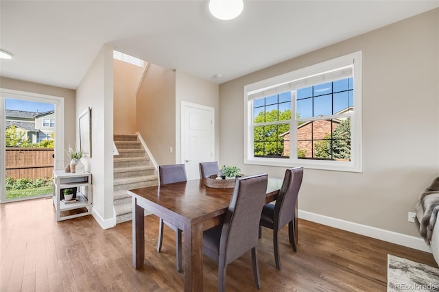 19294 E Warren Pl, Aurora, CO 80013 - dining space featuring wood finished floors, baseboards, and stairs