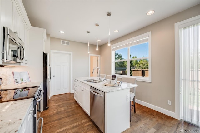 19294 E Warren Pl, Aurora, CO 80013 - kitchen featuring appliances with stainless steel finishes, a sink, wood finished floors, white cabinets, and recessed lighting