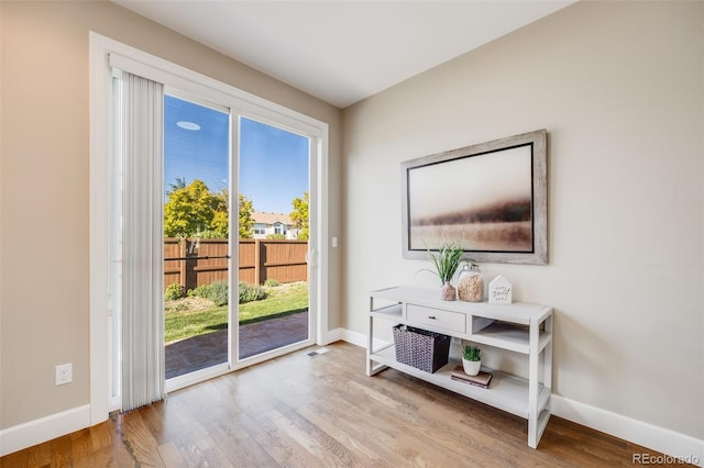 19294 E Warren Pl, Aurora, CO 80013 - doorway to outside with baseboards and wood finished floors