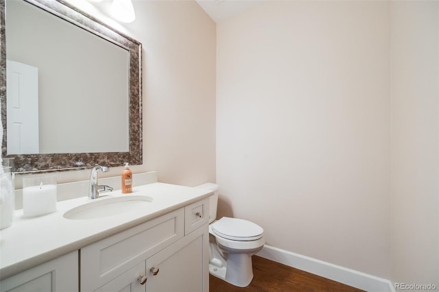 19294 E Warren Pl, Aurora, CO 80013 - half bathroom with toilet, vanity, wood finished floors, and baseboards